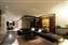 Recessed lighting creates a soft atmosphere in this sleek, modern living room